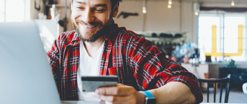 a man preparing to make an online payment with a debit/credit card