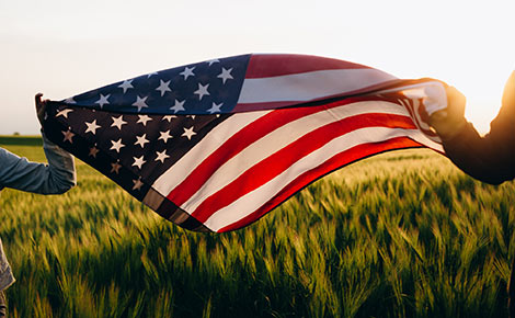 two people holding an american flag