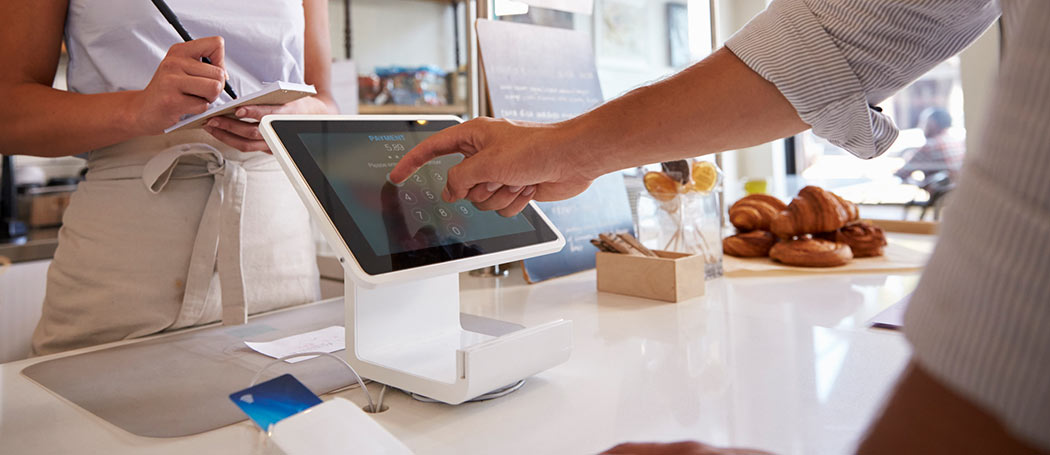 a person paying for a product at a bakery store