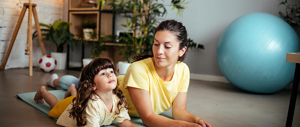 mother and daughter doing yoga